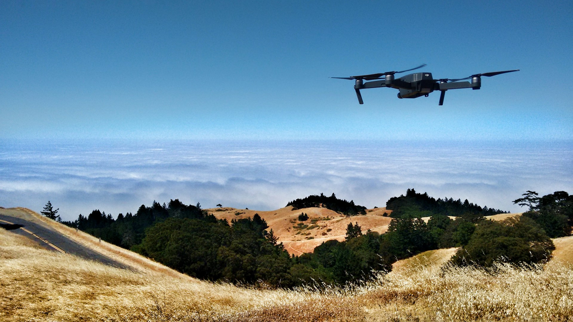 dji drone flying over mountains